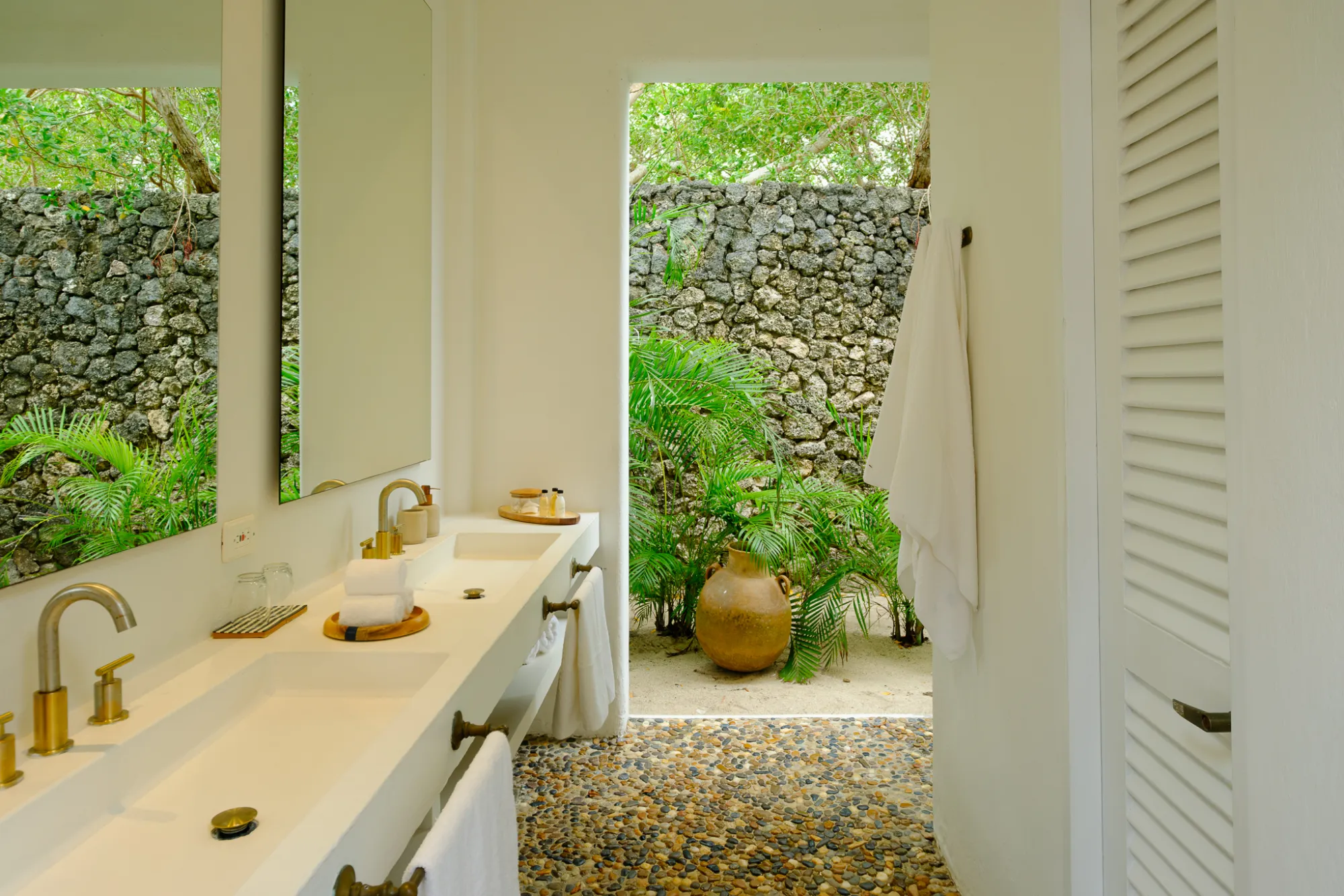 A bathroom opening onto a walled garden
