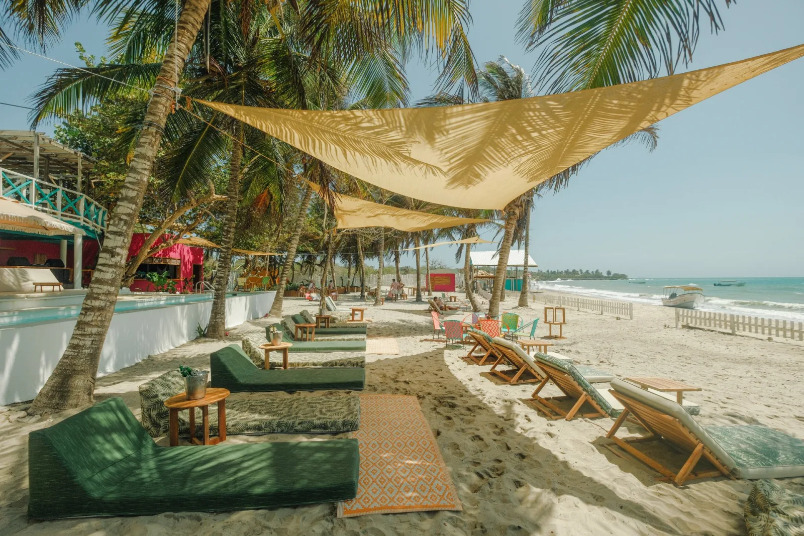 Loungers on the sand at The Pink Mango, Isla Tierra Bomba